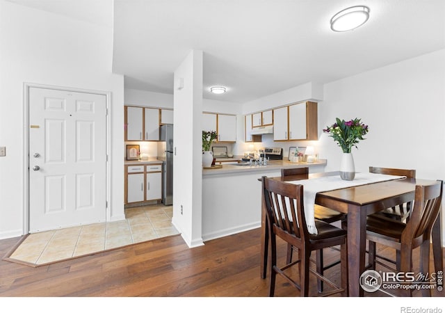 dining area with light wood-style floors