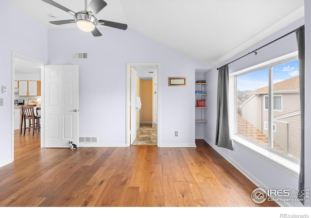 unfurnished bedroom featuring access to outside, wood finished floors, visible vents, and baseboards