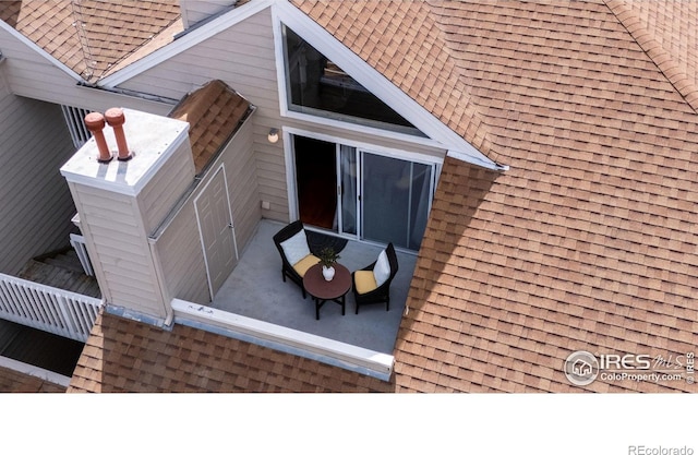 view of side of property with a shingled roof