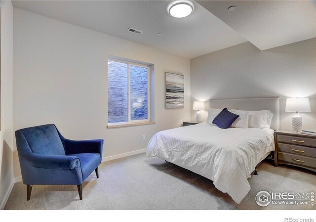 bedroom featuring carpet floors, visible vents, and baseboards