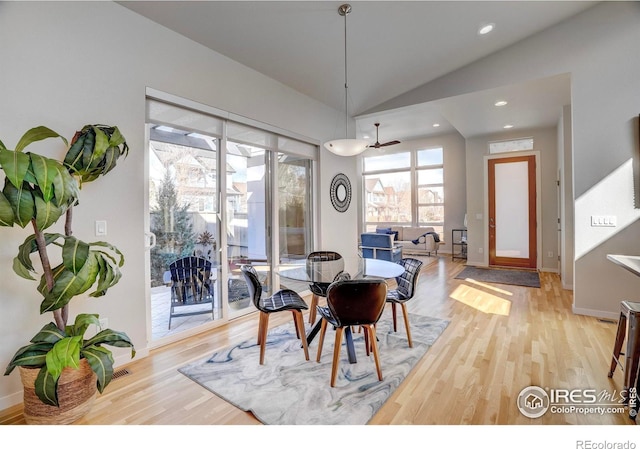 dining room featuring vaulted ceiling, light wood finished floors, baseboards, and recessed lighting