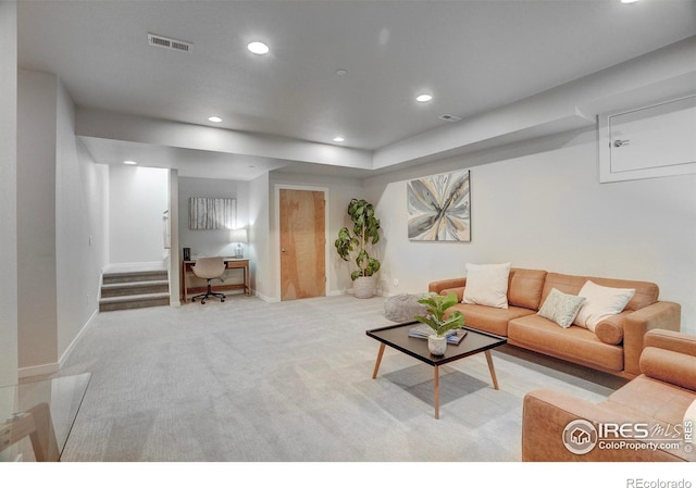 living room with light colored carpet, recessed lighting, visible vents, and baseboards