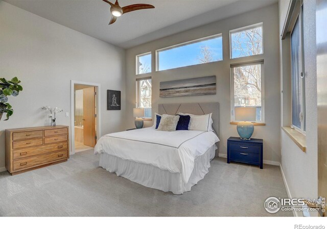 bedroom with carpet floors, a towering ceiling, and baseboards