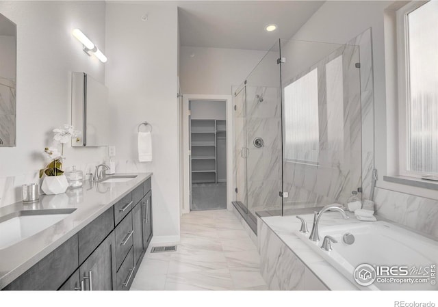 full bathroom with marble finish floor, a marble finish shower, visible vents, a sink, and a bath