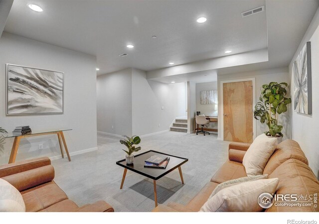 living room featuring baseboards, stairs, visible vents, and recessed lighting