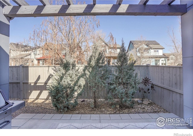 view of yard with a patio area, a fenced backyard, a residential view, and a pergola