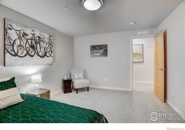 carpeted bedroom featuring visible vents and baseboards