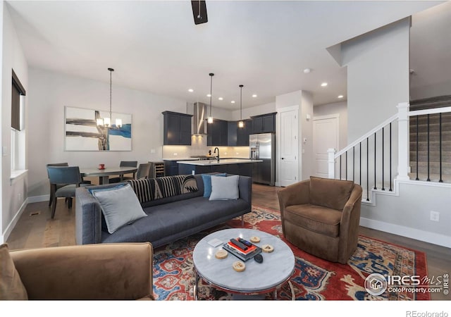 2748 Prairie Flax St, Berthoud, CO 80513 - living area with recessed lighting, a notable chandelier, stairway, and dark wood-style flooring