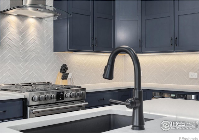 2748 Prairie Flax St, Berthoud, CO 80513 - interior space with wall chimney range hood, light countertops, stainless steel gas stove, and decorative backsplash