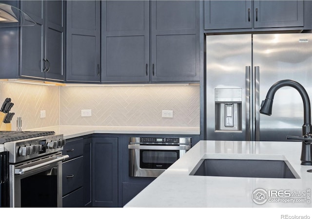 2748 Prairie Flax St, Berthoud, CO 80513 - kitchen with a sink, backsplash, and stainless steel appliances