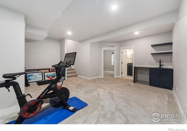 2748 Prairie Flax St, Berthoud, CO 80513 - exercise room with light colored carpet, wet bar, recessed lighting, a sink, and baseboards