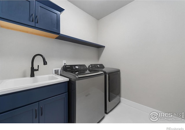 2748 Prairie Flax St, Berthoud, CO 80513 - clothes washing area featuring separate washer and dryer, baseboards, a sink, and cabinet space