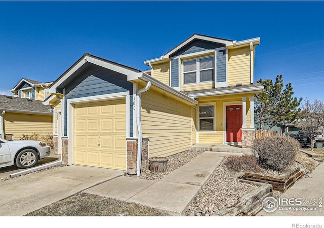 view of front of home with concrete driveway and an attached garage