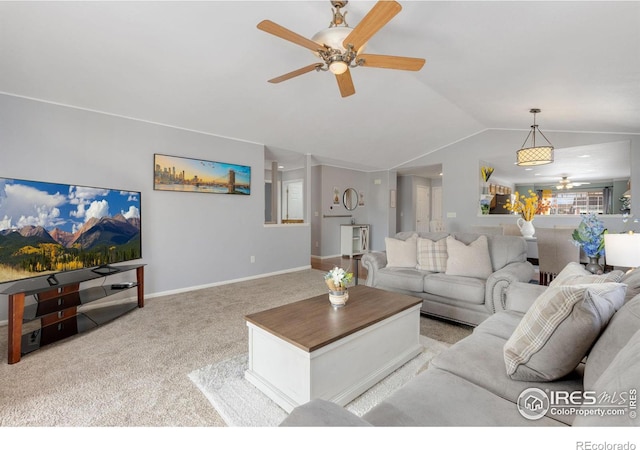 living area featuring carpet floors, vaulted ceiling, baseboards, and a ceiling fan