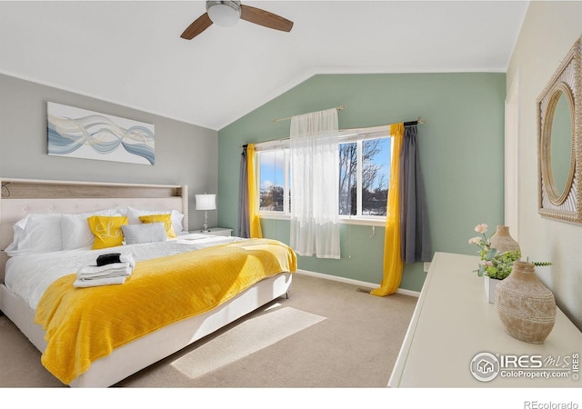 bedroom with ceiling fan, carpet, baseboards, and vaulted ceiling