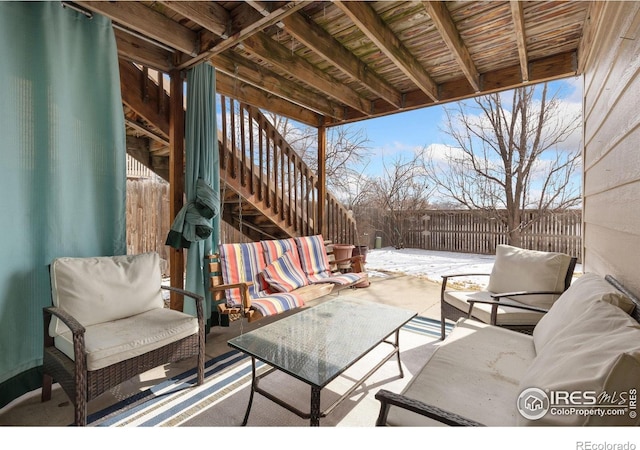 view of patio featuring a fenced backyard, an outdoor living space, and stairs