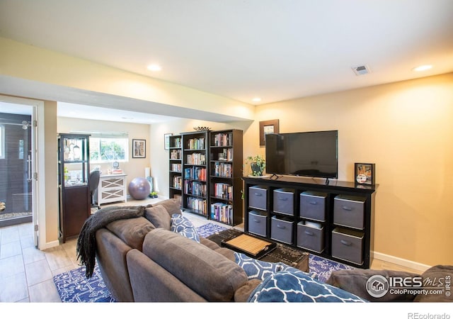 living area featuring recessed lighting, visible vents, and baseboards