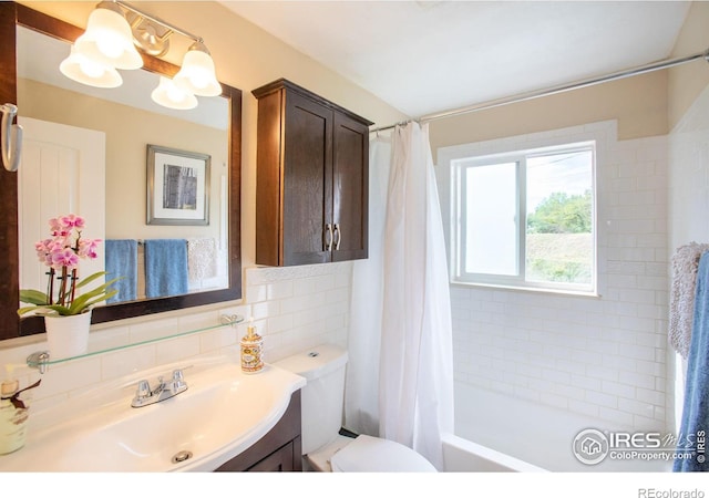 full bathroom featuring tile walls, toilet, decorative backsplash, shower / tub combo, and vanity