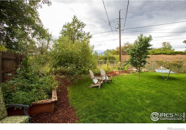 view of yard featuring a garden and fence