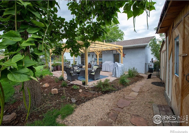 exterior space with a gate, a grill, fence, and a pergola