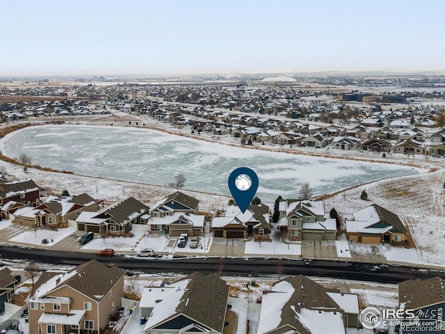 snowy aerial view with a residential view