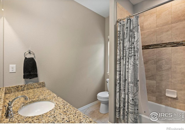 full bathroom featuring shower / bath combo with shower curtain, tile patterned flooring, a sink, and toilet