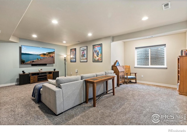 carpeted living room featuring baseboards, visible vents, and recessed lighting