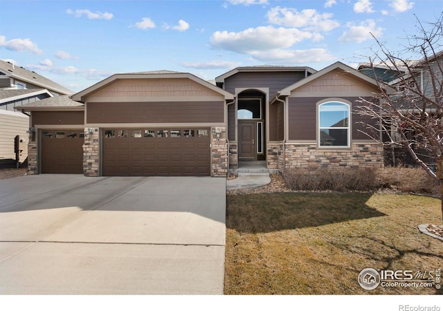 view of front of property with a garage, stone siding, driveway, and a front lawn