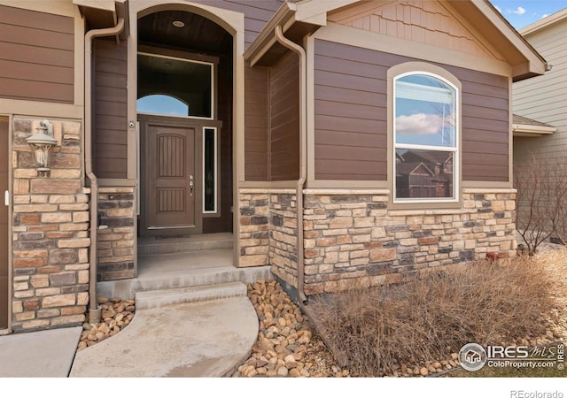 property entrance with stone siding