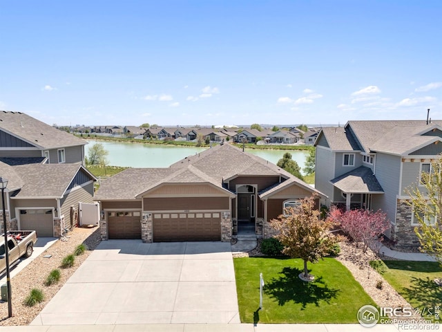 480 Boxwood Dr, Windsor, CO 80550 - view of front of home with a residential view, an attached garage, a water view, and concrete driveway