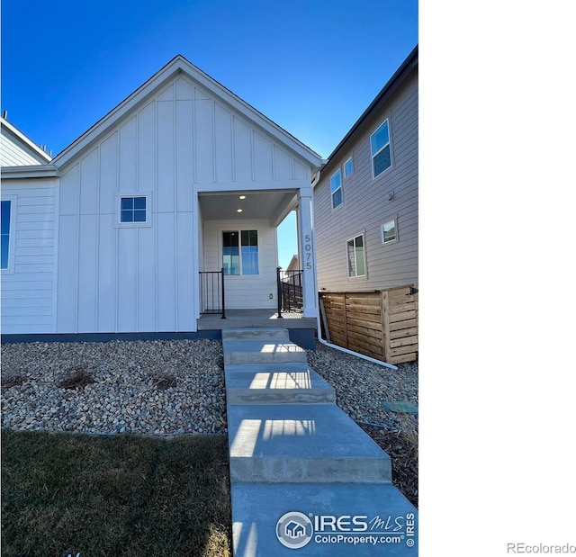 back of property featuring board and batten siding and a porch