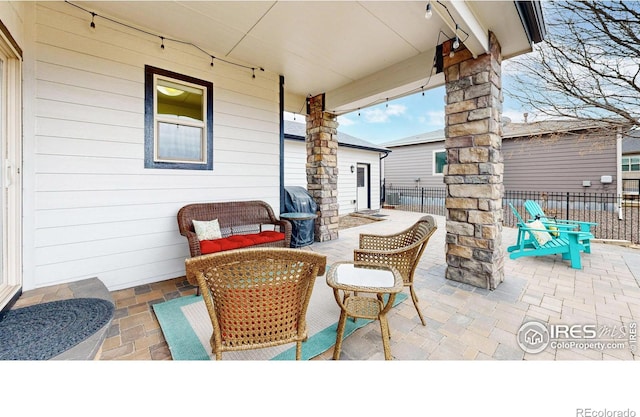 view of patio with central AC unit, fence, and outdoor lounge area