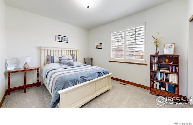 bedroom featuring baseboards, visible vents, and carpet flooring