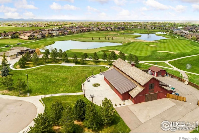 birds eye view of property with a water view and golf course view