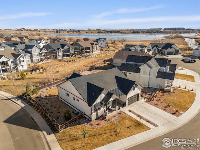 drone / aerial view featuring a water view and a residential view