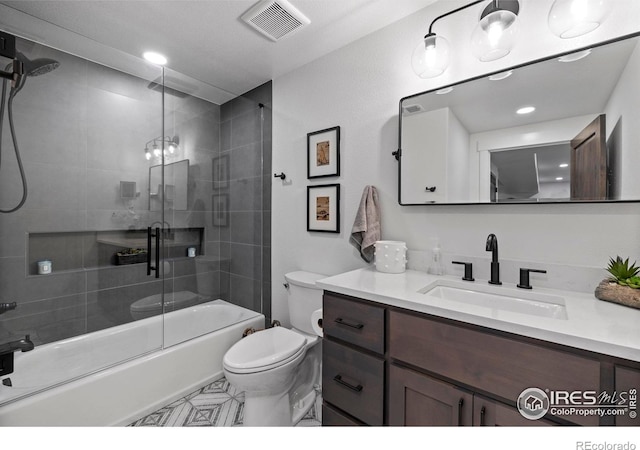 full bath featuring enclosed tub / shower combo, visible vents, vanity, and toilet