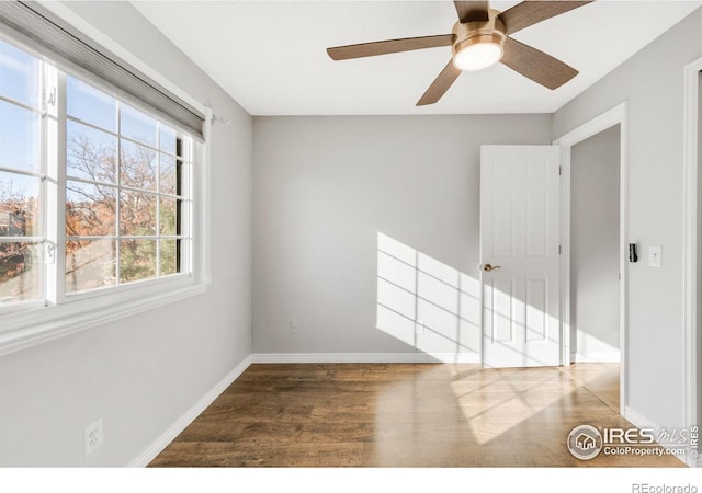 empty room featuring baseboards and wood finished floors