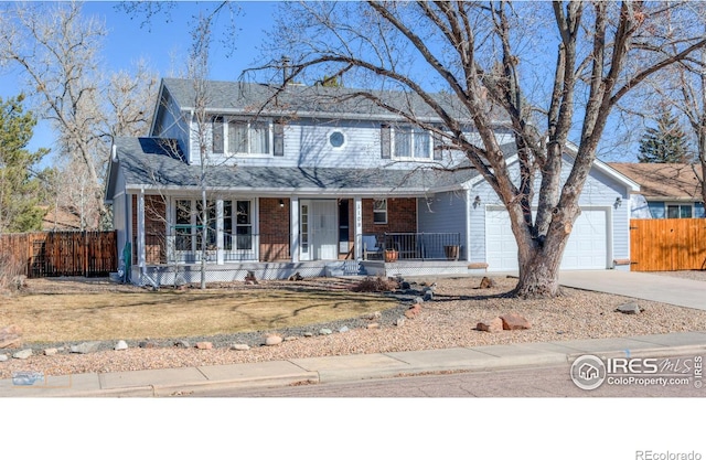 view of front of house featuring driveway, an attached garage, fence, a porch, and brick siding