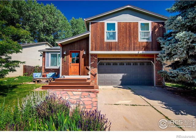 tri-level home featuring driveway, brick siding, and an attached garage