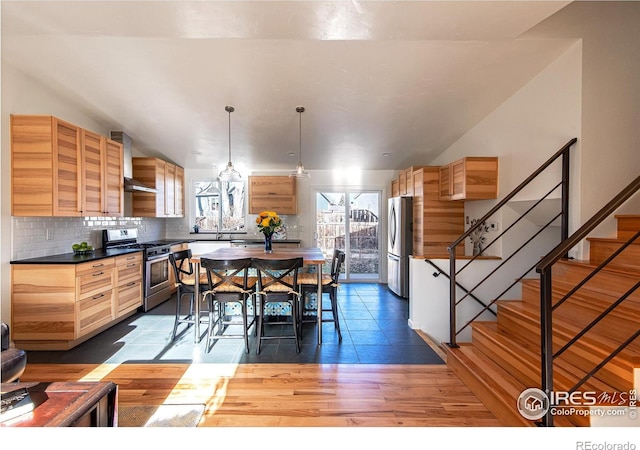 dining area with stairway and wood finished floors