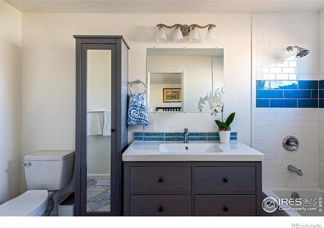 bathroom with toilet,  shower combination, and vanity