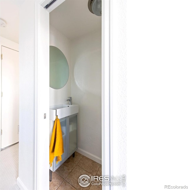 bathroom with a sink and tile patterned floors