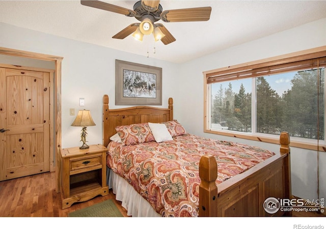 bedroom featuring light wood-type flooring and ceiling fan