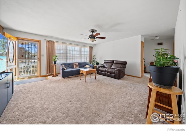 living area featuring carpet and a ceiling fan