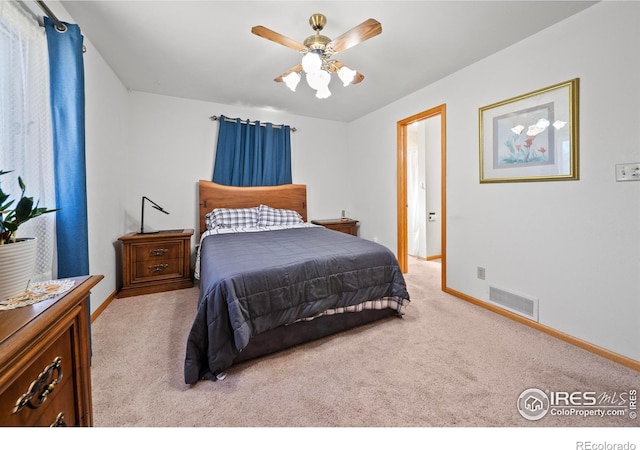 bedroom with carpet floors, visible vents, ceiling fan, and baseboards