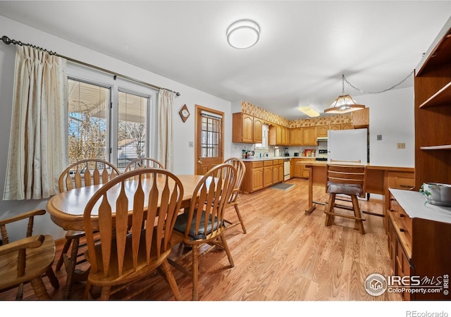 dining space featuring light wood-type flooring