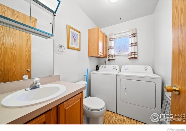 bathroom featuring vanity, toilet, and separate washer and dryer