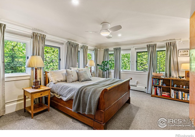 bedroom featuring a baseboard heating unit, carpet flooring, and a ceiling fan