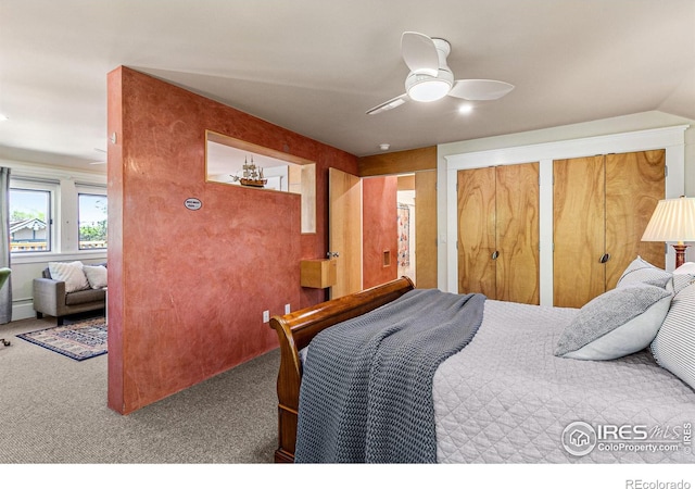 carpeted bedroom featuring a ceiling fan and multiple closets