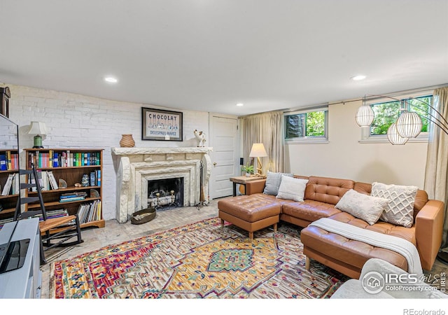 living area with a premium fireplace and recessed lighting